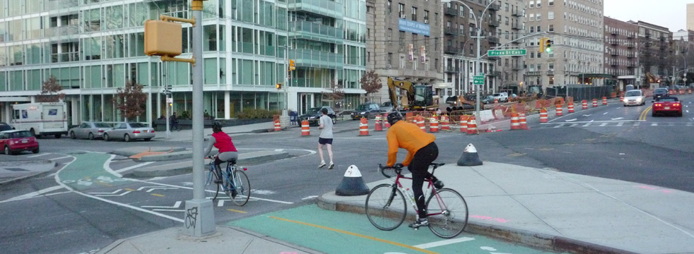 Cyclists, pedestrians, and cars on a NYC street